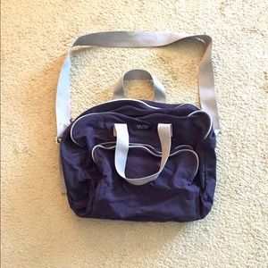 Nautical travel bag, zipper open with side pocket.